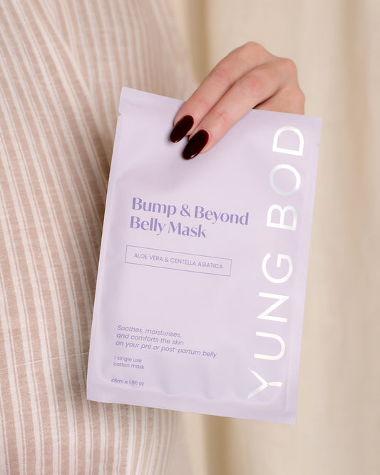 YUNG BOD belly mask packaging held by a hand with dark nail polish on a neutral background